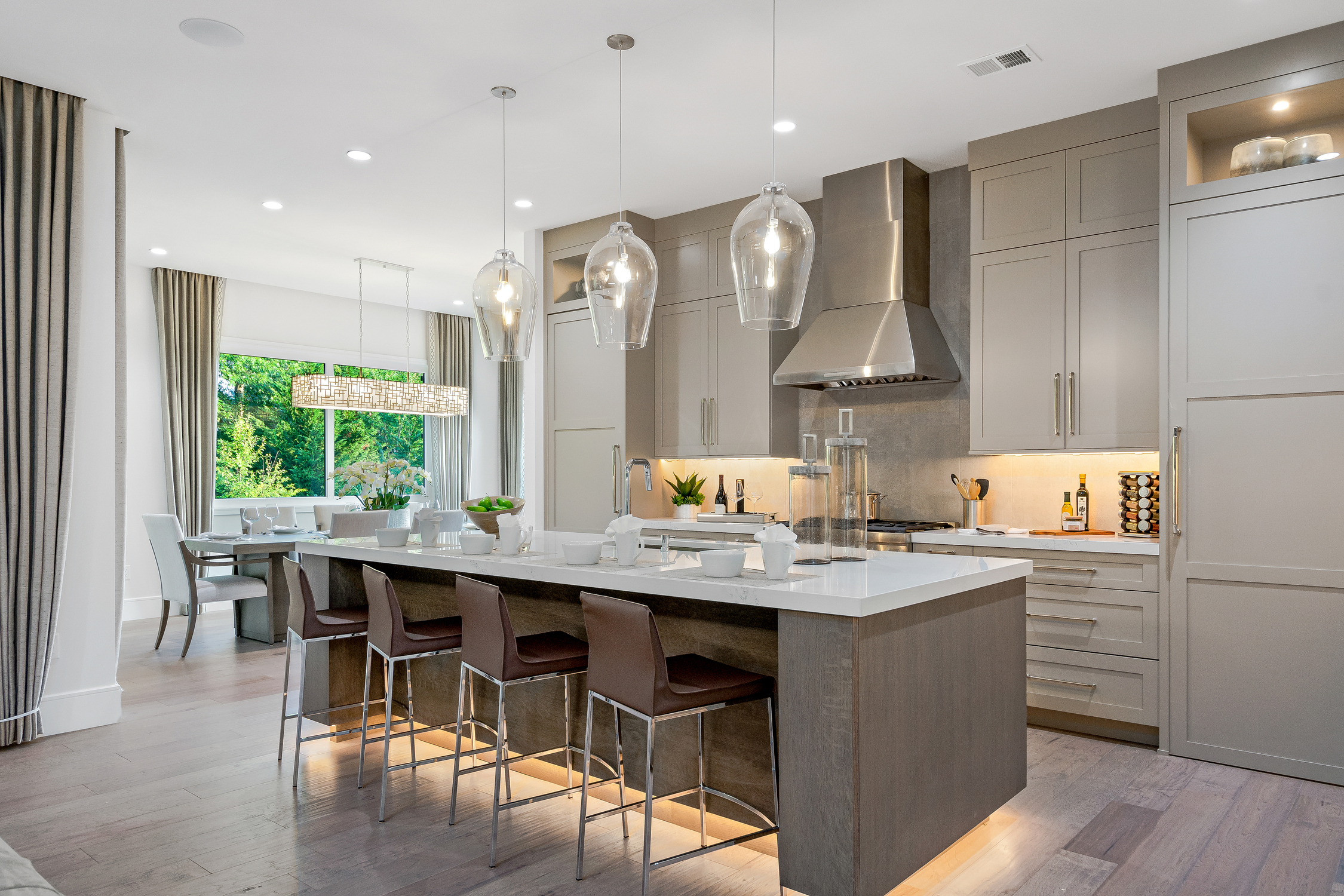 Modern taupe kitchen island with seating in a Connecticut remodel