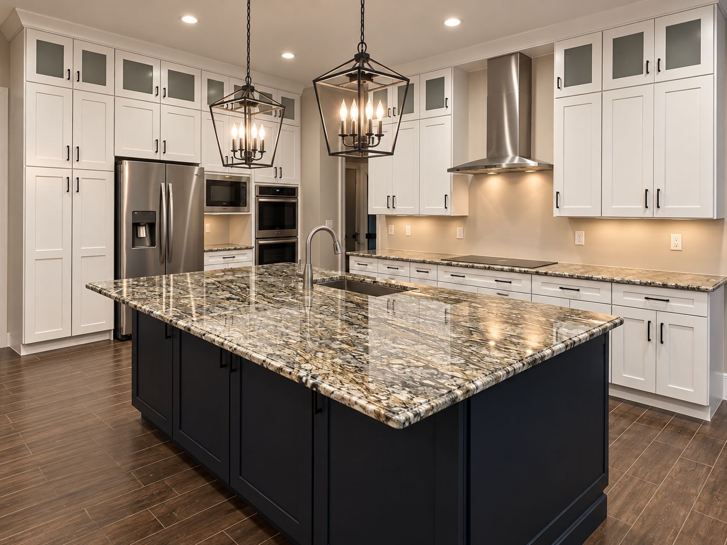 Luxury white Shaker kitchen in Darien CT featuring a dark island, stone countertops and black pendant lights